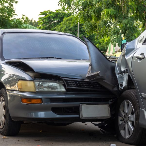 Car crash accident on street with wreck and damaged automobiles. Accident caused by negligence And lack of ability to drive. Due to illness