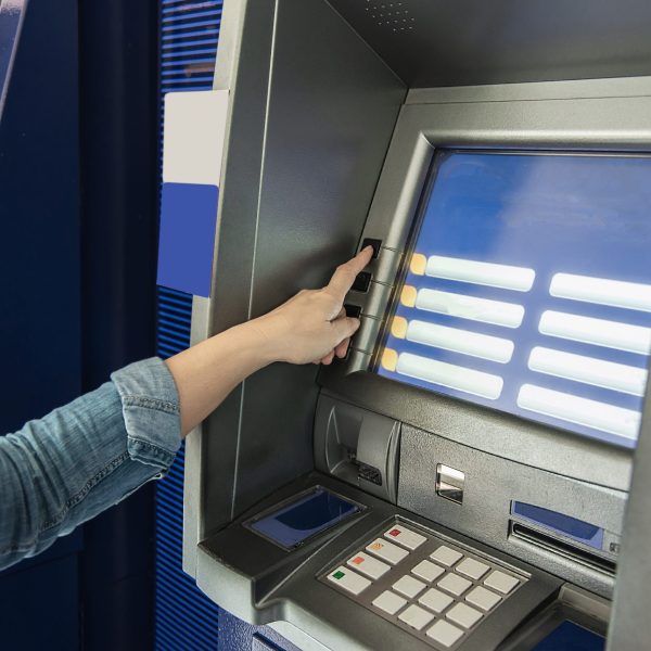 People waiting to get money from automated teller machine - people withdrawn money from ATM concept